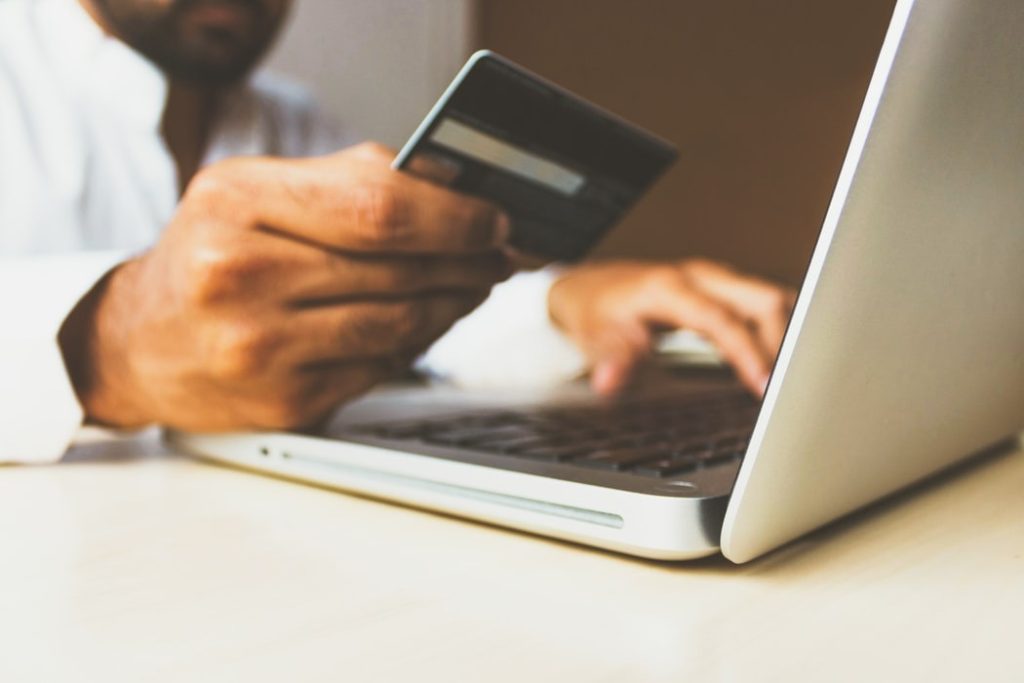 homem comprando passagem de onibus online com cartão de crédito